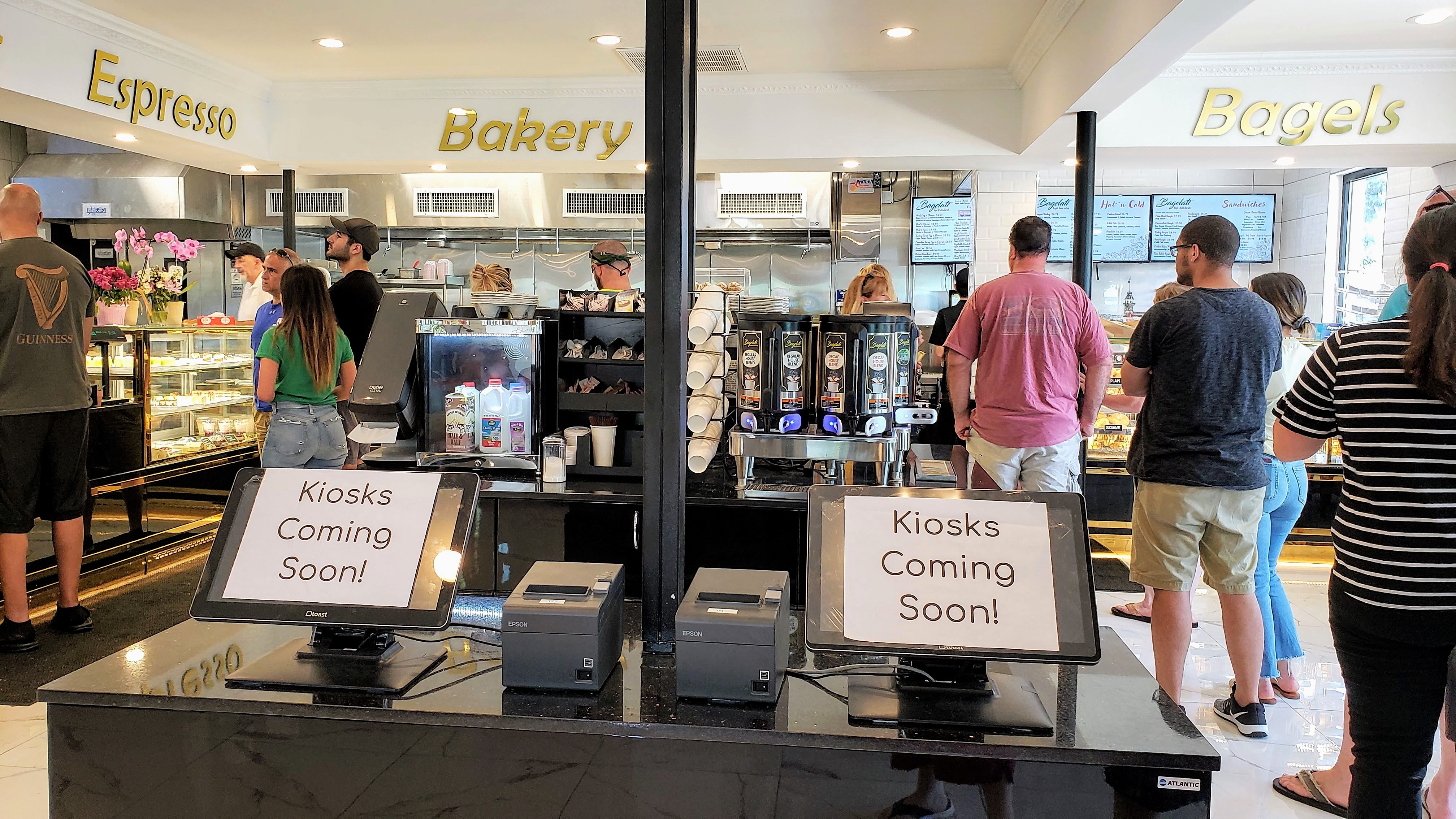 Busy interior of Bagelati showing espresso, bakery, and bagels sections